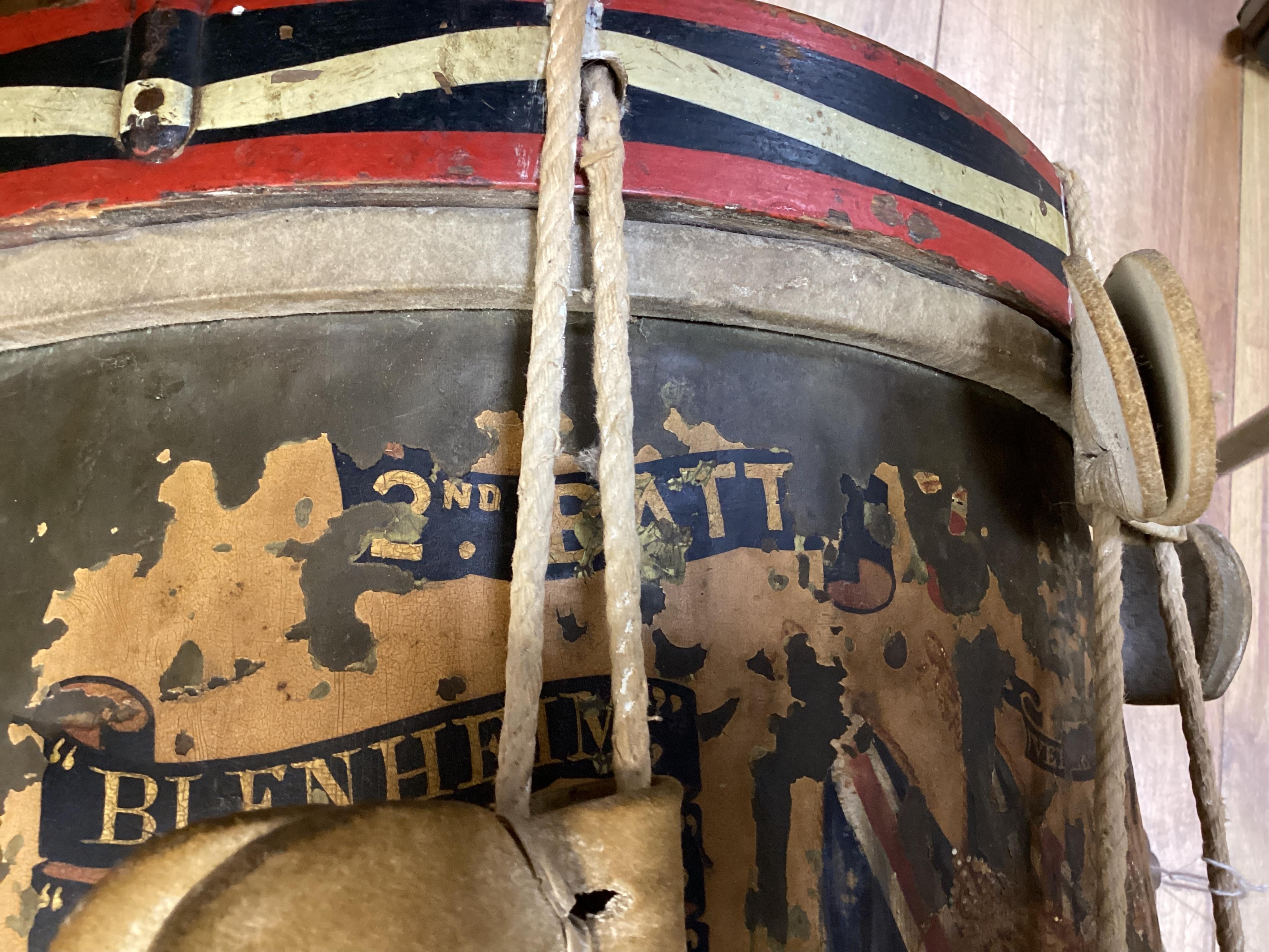 A late 19th/early 20th century Royal East Kent Regiment 'Buffs' regimental drum, 37cm diameter, 37cm high, together with a rope edged, stained pine removable 'table top' adaption